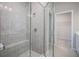 Modern bathroom featuring a tiled shower with a built-in bench and glass door at 1556 Covey Rise Ter, Winter Haven, FL 33884