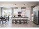 Bright modern kitchen with stainless steel appliances, large island with seating, and an adjacent dining area at 1556 Covey Rise Ter, Winter Haven, FL 33884
