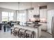 Beautiful kitchen with stainless appliances, granite island with seating, pendant lighting and dining area at 1556 Covey Rise Ter, Winter Haven, FL 33884