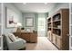 Cozy home office with natural wood furniture, ample storage, and bright, light-filled windows at 1556 Covey Rise Ter, Winter Haven, FL 33884