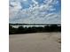 Scenic view of a tranquil lake surrounded by lush greenery, providing a serene and peaceful backdrop at 1556 Covey Rise Ter, Winter Haven, FL 33884