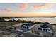 An aerial view of two new homes showcases the desirable waterfront location and community at 1560 Covey Rise Ter, Winter Haven, FL 33884