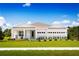 Charming single-story home featuring a well-manicured lawn, three-car garage, and tasteful landscaping at 1560 Covey Rise Ter, Winter Haven, FL 33884