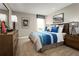 Tastefully decorated bedroom featuring a bed with a unique blue striped design and surf-themed artwork at 3186 Tiger Palm Way, New Smyrna Beach, FL 32168