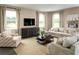 Cozy living room featuring neutral tones, comfortable seating, and a large TV for entertainment and relaxation at 3186 Tiger Palm Way, New Smyrna Beach, FL 32168