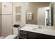 Well-lit bathroom featuring a sleek vanity, decorative wall art, and tiled shower with a modern design at 3190 Tiger Palm Way, New Smyrna Beach, FL 32168