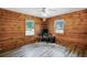 Study featuring wood paneling, wood-look floors, and two windows at 2955 Se 156Th Place Rd, Summerfield, FL 34491