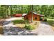 Log cabin with a wrap-around driveway and a large storage shed, offering convenience and space at 2955 Se 156Th Place Rd, Summerfield, FL 34491