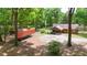 Log cabin featuring covered parking, complemented by a spacious driveway and natural surroundings at 2955 Se 156Th Place Rd, Summerfield, FL 34491