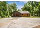 Charming log cabin home with a covered porch and driveway, nestled among mature trees at 2955 Se 156Th Place Rd, Summerfield, FL 34491
