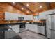 Bright kitchen featuring white cabinets, stainless steel appliances, and dark countertops at 2955 Se 156Th Place Rd, Summerfield, FL 34491