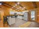 Open kitchen with white cabinetry, stainless steel appliances, breakfast bar and wood ceiling at 2955 Se 156Th Place Rd, Summerfield, FL 34491