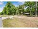Expansive lot with a well-maintained lawn, mature trees, and a charming home in the distance at 2955 Se 156Th Place Rd, Summerfield, FL 34491