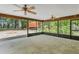 Spacious screened porch with ceiling fans, offering outdoor views of the lush, surrounding landscape at 2955 Se 156Th Place Rd, Summerfield, FL 34491
