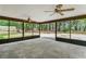 Large screened porch with ceiling fans, providing an inviting space to enjoy the surrounding woods at 2955 Se 156Th Place Rd, Summerfield, FL 34491