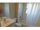 Clean bathroom featuring a shower and tub combination with white tile, a sink, and a toilet at 3806 Osprey Pointe Cir, Winter Haven, FL 33884