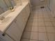 Bathroom featuring a double vanity, tile flooring, and walk-in shower at 3806 Osprey Pointe Cir, Winter Haven, FL 33884