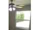 Bright bedroom with a ceiling fan and a large window overlooking the well maintained lawn at 3806 Osprey Pointe Cir, Winter Haven, FL 33884