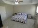 Spacious bedroom with a ceiling fan, neutral walls, and white wood-look floors at 3806 Osprey Pointe Cir, Winter Haven, FL 33884