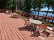 Spacious outdoor deck with views of the lake and tables perfect for relaxation and entertainment at 3806 Osprey Pointe Cir, Winter Haven, FL 33884