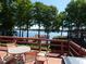 Outdoor deck with lake view, complete with outdoor seating ideal for relaxation at 3806 Osprey Pointe Cir, Winter Haven, FL 33884