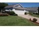 Well-maintained home with a manicured lawn, lush landscaping, and a spacious two-car garage at 3806 Osprey Pointe Cir, Winter Haven, FL 33884