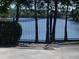 Iron gate offering secure access to the lake, surrounded by trees and lush greenery at 3806 Osprey Pointe Cir, Winter Haven, FL 33884