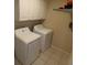 Laundry room featuring white washer and dryer units with upper cabinets at 3806 Osprey Pointe Cir, Winter Haven, FL 33884