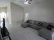 Bright living room showcasing a neutral-colored sectional sofa and tiled floors at 3806 Osprey Pointe Cir, Winter Haven, FL 33884