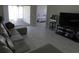 Comfortable living room featuring tile floors, neutral paint, and a sliding door leading to the outdoor area at 3806 Osprey Pointe Cir, Winter Haven, FL 33884