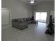 Spacious living room with modern furnishings, wood-look flooring, and sliding glass doors at 3806 Osprey Pointe Cir, Winter Haven, FL 33884