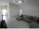 Bright living room showcasing a neutral-colored sectional sofa and tiled floors at 3806 Osprey Pointe Cir, Winter Haven, FL 33884