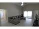 Large living room featuring a grey sectional, vaulted ceilings, and a sliding glass door to the outside at 3806 Osprey Pointe Cir, Winter Haven, FL 33884