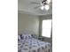 Cozy main bedroom featuring a comfortable bed, a ceiling fan, and a window providing natural light at 3806 Osprey Pointe Cir, Winter Haven, FL 33884