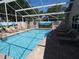 Well-lit pool with clear blue water and ample space for relaxation and recreation at 3806 Osprey Pointe Cir, Winter Haven, FL 33884