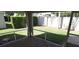 Enclosed patio space with a view of the well-maintained lawn and surrounding foliage at 3806 Osprey Pointe Cir, Winter Haven, FL 33884