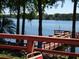 Scenic view of the lake from the wood deck, surrounded by lush trees creating a peaceful atmosphere at 3806 Osprey Pointe Cir, Winter Haven, FL 33884