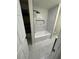 Modern bathroom with marble floors, a new bathtub and tiled walls at 601 Lantern Ln, Orange City, FL 32763