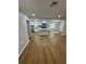 Open concept living area with hardwood floors that flows to the updated kitchen at 601 Lantern Ln, Orange City, FL 32763