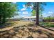A large backyard featuring a deck, trees, and a view of the back of the house at 201 Lake Gene Dr, Longwood, FL 32779