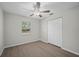 Neutral bedroom features light hardwood floors, a ceiling fan, and a closet at 201 Lake Gene Dr, Longwood, FL 32779