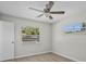 Bright bedroom featuring a ceiling fan, light hardwood floors, and a view from two windows at 201 Lake Gene Dr, Longwood, FL 32779