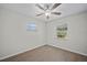 Neutral bedroom featuring light hardwood floors, a ceiling fan, and windows at 201 Lake Gene Dr, Longwood, FL 32779