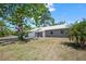 Charming single-story home with stone accents, a metal roof, and a well-maintained front yard at 201 Lake Gene Dr, Longwood, FL 32779