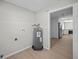 Laundry room with white walls, a water heater and access to the updated kitchen at 201 Lake Gene Dr, Longwood, FL 32779