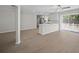 Open-concept living space with wood flooring, seamlessly connecting the living area and a modern kitchen at 201 Lake Gene Dr, Longwood, FL 32779