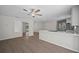 Open living room with wood floors, neutral paint and bar seating into the kitchen at 201 Lake Gene Dr, Longwood, FL 32779