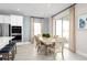 Dining area with table and seating adjacent to kitchen and sliding glass doors at 2028 Havasu Falls Dr, Deland, FL 32724