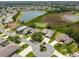 High-angle shot of a home near a lake, showing neighborhood design and natural features at 27223 Nostalgia Dr, Leesburg, FL 34748