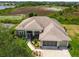 Overhead shot of a well-maintained home with a screened front porch and expansive roof at 27223 Nostalgia Dr, Leesburg, FL 34748